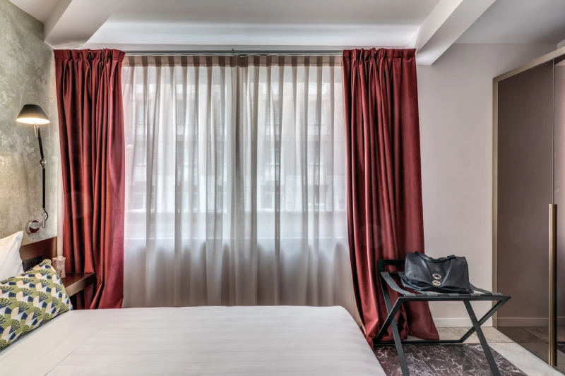 Bright window with red curtains and relaxation area in room near Palazzo Barberini Rome - Barberini 16, BZAR hotels in Rome